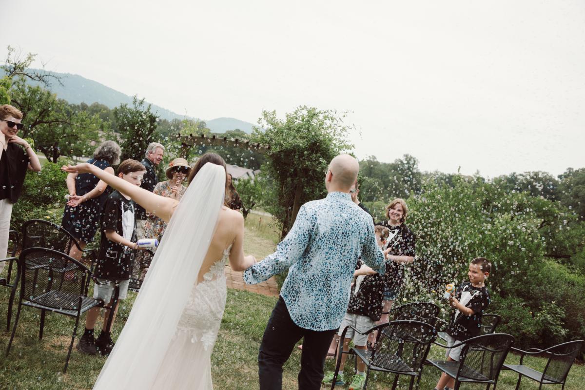 Amy Mitchell Photography Day of I Do's Microwedding photo of bride Effie, taken by Amy Mitchell Photography. Microwedding with bubbles